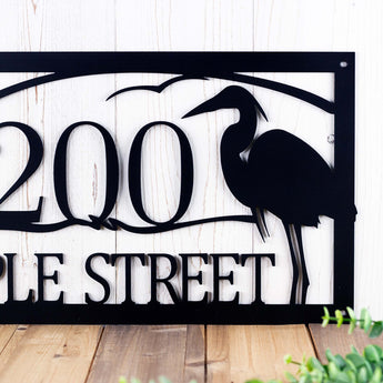 Close up of great blue heron and house number on our rectangular metal address sign, in matte black powder coat.