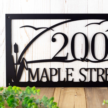 Close up of cattails and house number on our rectangular metal address sign, in matte black powder coat.