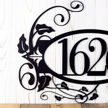 Close up of fleur de lis and vines on our 4 digit metal house number sign, in matte black powder coat.