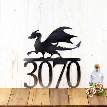 4 digit metal house number sign with a dragon silhouette, in raw steel. 