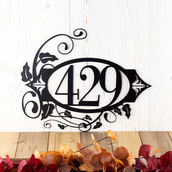 Oval 3 digit metal house number sign with vines and fleur de lis, in matte black powder coat.