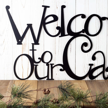 Close up of Welcome to our Cabin metal sign, in matte black powder coat.