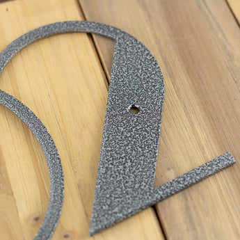 Close up of silver vein powder coat on our modern metal house number sign.