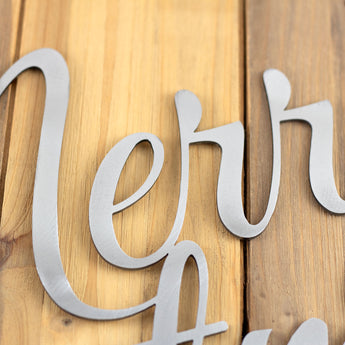 Close up of raw steel on our Merry Christmas script sign. 