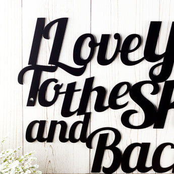 Close up of I Love You To The Sky and Back metal sign, in matte black powder coat.