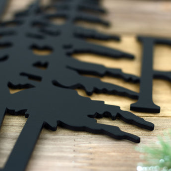Close up of matte black powder coat on our metal family name sign.