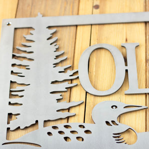 Close up of raw steel on our loon family name sign.