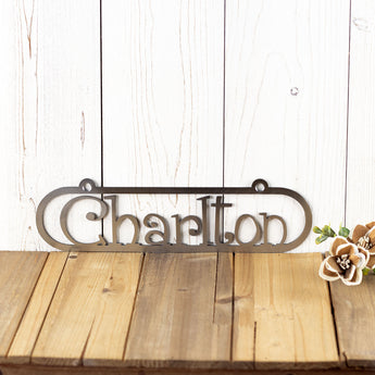 Close up of child name on our custom metal sign, in raw steel.