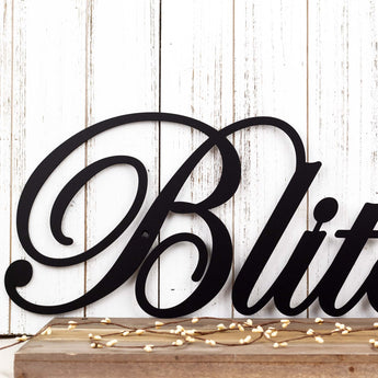 Close up of script lettering on our family name metal wall art, in matte black powder coat. 