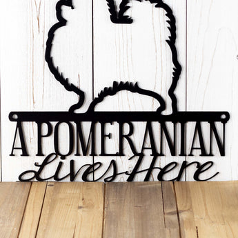 Close up of A Pomeranian Lives Here wording onr our Pomeranian metal sign, in matte black powder coat.