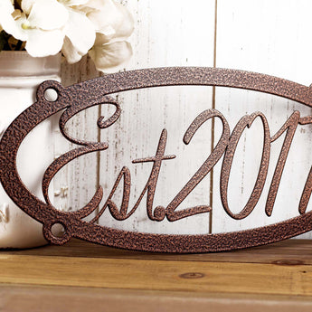 Close up of established year on our oval metal sign, in copper vein powder coat.