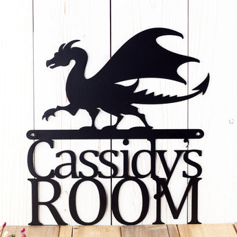 Close up of our personalized dragon name metal sign, in matte black powder coat.