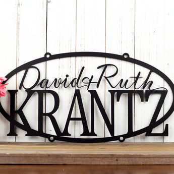 Personalized oval metal sign with first and last names, in matte black powder coat. 
