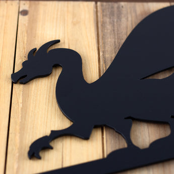 Close up of Dragon silhouette on our custom child's room metal sign, in matte black powder coat.