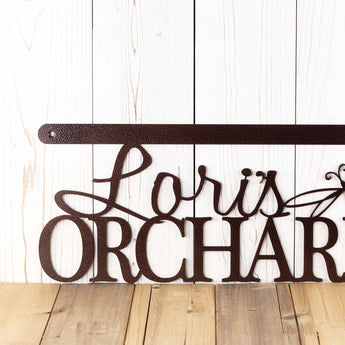 Close up of first name on our hanging metal orchard sign, in copper vein powder coat.