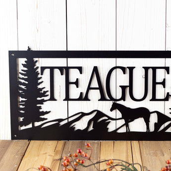 Close up of our rectangular family name metal sign with a horse silhouette, in matte black powder coat.