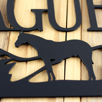 Close up of matte black powder coat on our rectangular family last name metal sign with horse silhouette.