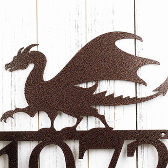 Close up of dragon silhouette on our metal house number sign, in copper vein powder coat. 