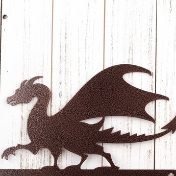 Close up of dragon silhouette on our metal address sign, in copper vein powder coat. 