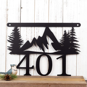 Hanging 3 digit metal house number sign with mountains and pine trees, in matte black powder coat. 