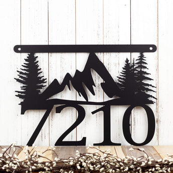 Hanging 4 digit metal house number sign with mountains and pine trees, in matte black powder coat. 