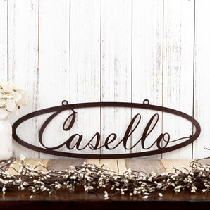 Oval family last name metal sign with script font, in copper vein powder coat.