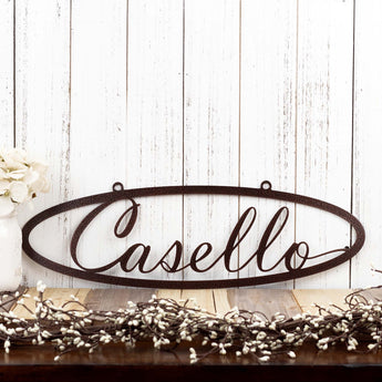 Oval family last name metal sign with script font, in copper vein powder coat.