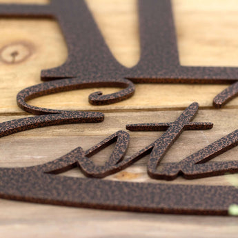 Close up of copper vein powder coat on our oval personalized family name sign. 