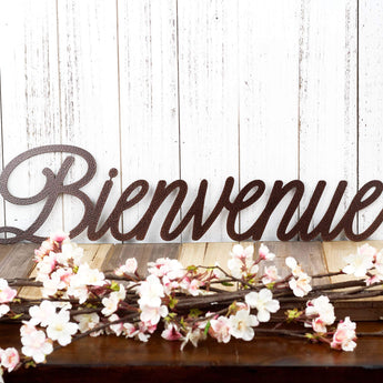 Bienvenue metal wall art in a script lettering, in copper vein powder coat.