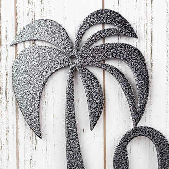 Close up of palm tree on our metal house number sign, in silver vein powder coat.