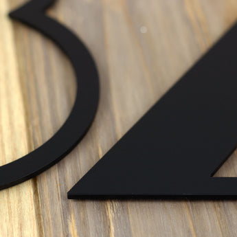 Close up of matte black powder coat on our modern metal house number sign.