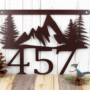 Hanging 3 digit metal house number sign with mountains and pine trees, in copper vein powder coat. 