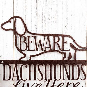 Close up of Dachshund dog silhouette with Beware on our Dachshund metal sign, in copper vein powder coat.