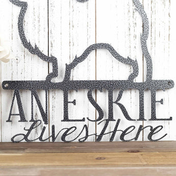 Close up of An Eskie Lives Here wording on our Eskie metal sign, in silver vein powder coat.