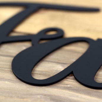 Close up of matte black powder coat on our Faith metal wall art.