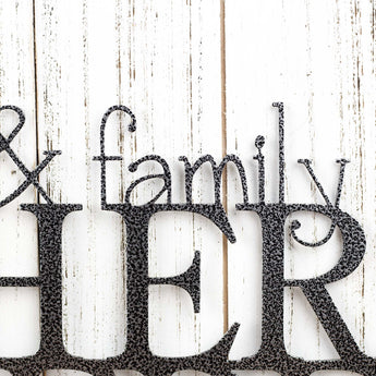 Close up of Family lettering on our Friends & Family Gather Here metal wall art, in silver vein powder coat.