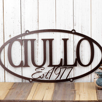 Hanging oval custom metal sign with family name and established year, in copper vein powder coat. 
