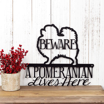 A Pomeranian Lives Here metal wall art, with Beware, in matte black powder coat. 