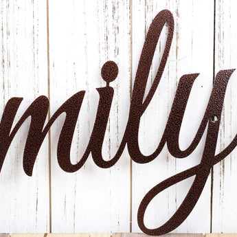 Close up of cursive writing on our family metal sign, in copper vein powder coat. 