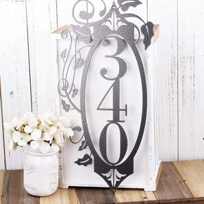 3 digit vertical metal house number sign with vines and fleur de lis, in silver vein powder coat. 
