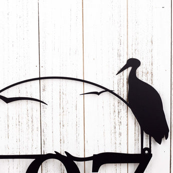 Close up of heron & cattails lake scene, on our 3 digit metal house number sign, in matte black powder coat.