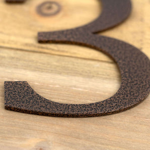 Close up of copper vein powder coat on the anchor house number.