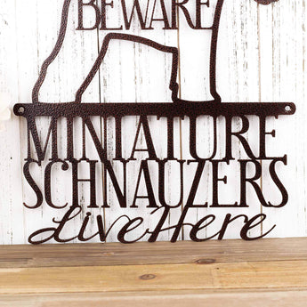 Close up of Miniature Schnauzers Live Here wording on our metal sign, in copper vein powder coat. 