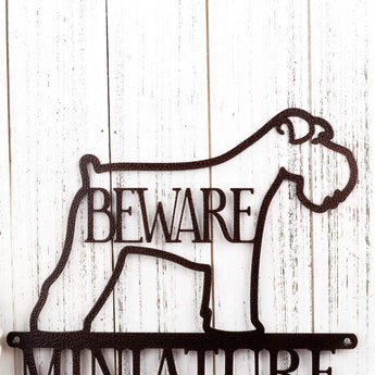 Close up of Miniature Schnauzer dog silhouette with Beware in the center, on our metal sign, in copper vein powder coat. 