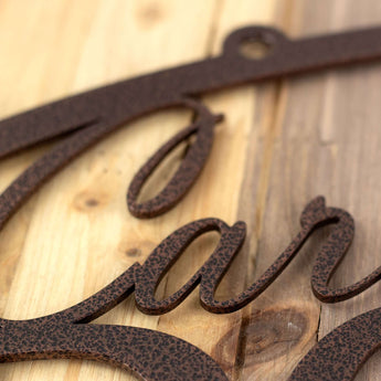 Close up of copper vein powder coat on our metal family name sign.
