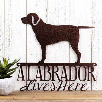 A Labrador Lives Here metal sign, in copper vein powder coat. 