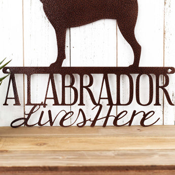 Close up of A Labrador Lives Here wording on our metal Labrador dog sign, in copper vein powder coat. 