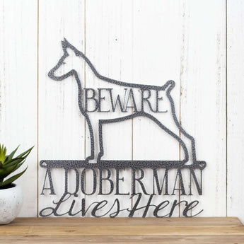 A Doberman Lives Here metal wall art, with Beware, in silver vein powder coat. 