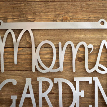 Close up of Mom's Garden hanging metal sign, in raw steel.