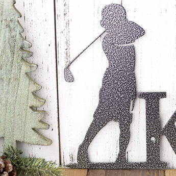 Close up of boy golfer on our custom name plaque, in silver vein powder coat. 